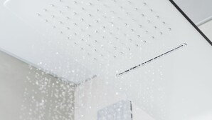 A white ceiling with a grid of small holes and a horizontal vent. - Elysium Self Check-In Rooms (Trezzo sull'Adda)