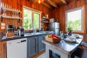 A wooden interior with a kitchen area, including a sink, microwave, and various kitchen appliances. - Le Chalet Des Oliviers: private pool, Wi-Fi, and air conditioning in Roquefort-la-Bédoule (Roquefort-la-Bédoule)