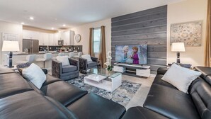 A modern living room with a sofa set, a coffee table, and a television.