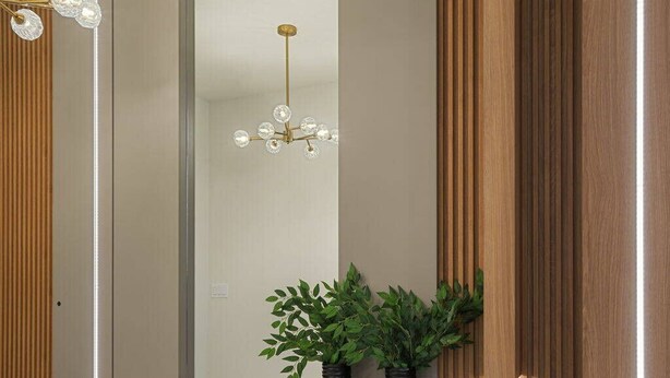 A modern interior with a wooden bench, two black vases with green plants, a hanging crystal chandelier, and vertical wooden slats.