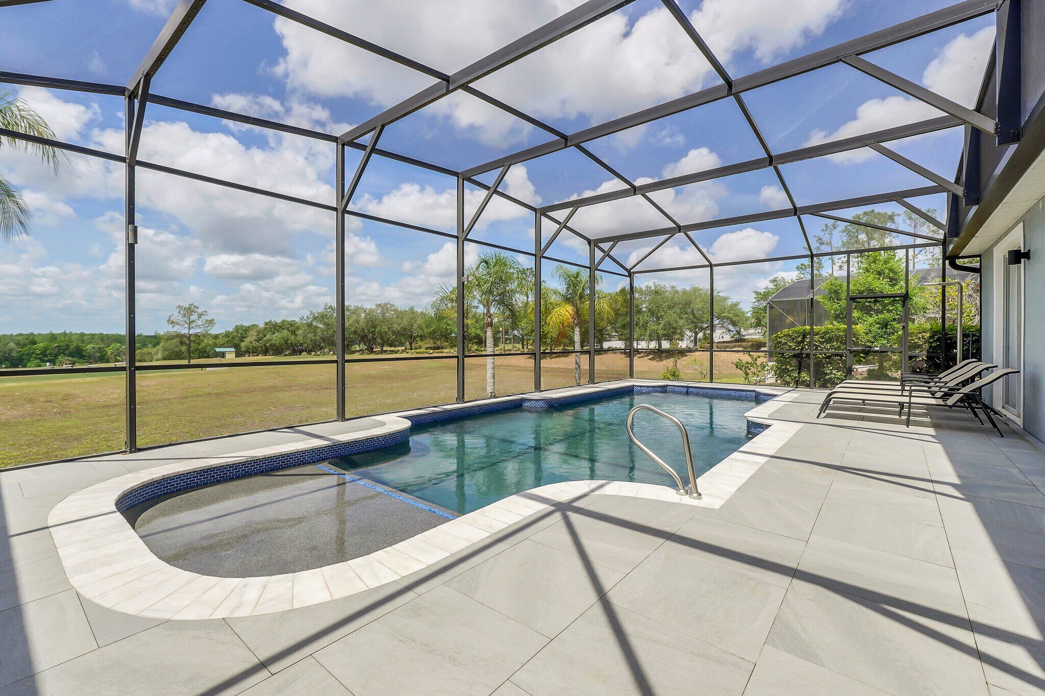 A covered outdoor swimming pool with a clear view of the surrounding landscape.