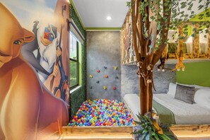 A room with a colorful ball pit, a climbing wall, and a mural. - Last Minute Disney! Private Pool, Game Room & Themed Bedrooms. Book Now! #118059 (Orlando)