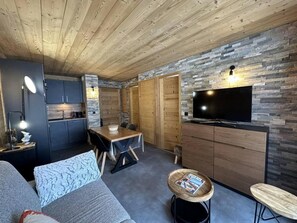 A compact living space with a kitchen, dining area, and seating area.