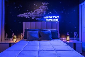 A bedroom with a large bed, a Star Wars-themed mural, and two nightstands with lights. - Disney! Private Pool, Game Room & Themed Bedrooms. Book Now! #SLR493 (Orlando)