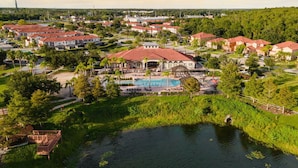 A residential area with houses, a swimming pool, and a river. - Disney Getaway! Private Pool & Game Room. Book Now! #BV77 (Orlando)