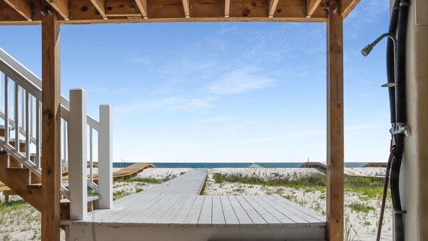 A wooden deck leading to a beach with a clear sky. - Las Brisas (Port St. Joe)