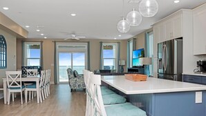A modern kitchen with a large island, stainless steel appliances, and a view to the outside. - Las Brisas (Port St. Joe)