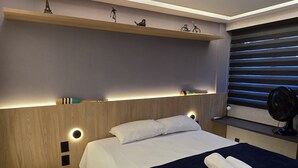 A modern bedroom with a bed, bedside table, and a small stool. - Flat vip 02C Bela Vista by La Playa (Ipojuca)