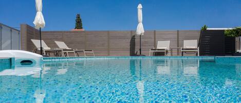 Outdoor pool, pool umbrellas, sun loungers