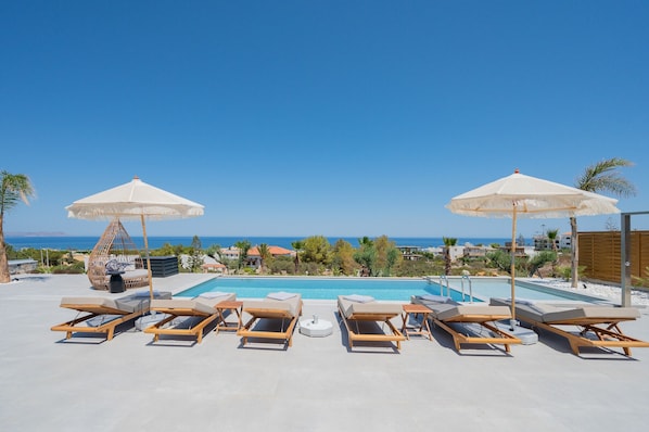 Outdoor pool, pool umbrellas, sun loungers