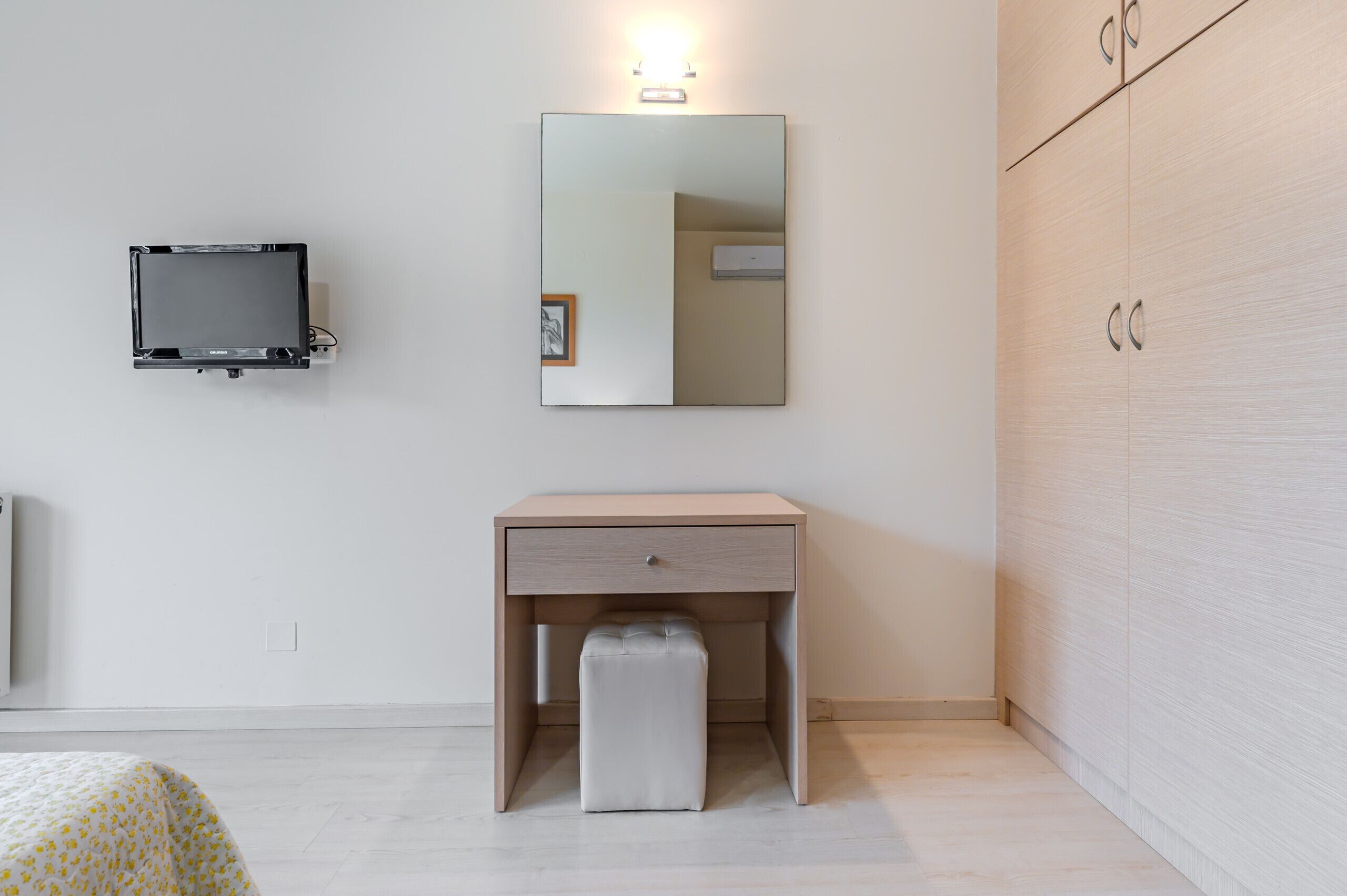 A modern bathroom with a mirror, a toilet, and a sink.