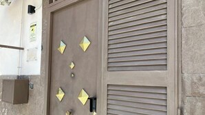 A door with geometric patterns and a security keypad.