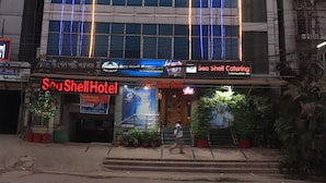 A hotel with a prominent sign reading "Sea Shell Hotel" and "Sea Shell Catering" below the entrance. - Sea Shell Hotel & Restaurant (Dhaka)