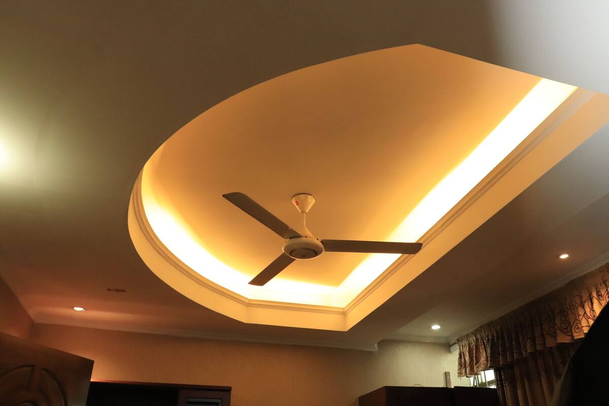 A ceiling with a recessed light fixture and a ceiling fan.
