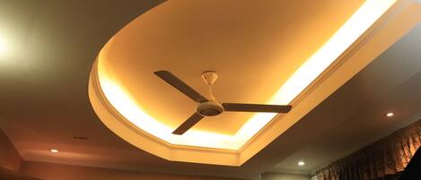 A ceiling with a recessed light fixture and a ceiling fan.