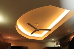 A ceiling with a recessed light fixture and a ceiling fan. - Sea Shell Hotel & Restaurant (Dhaka)