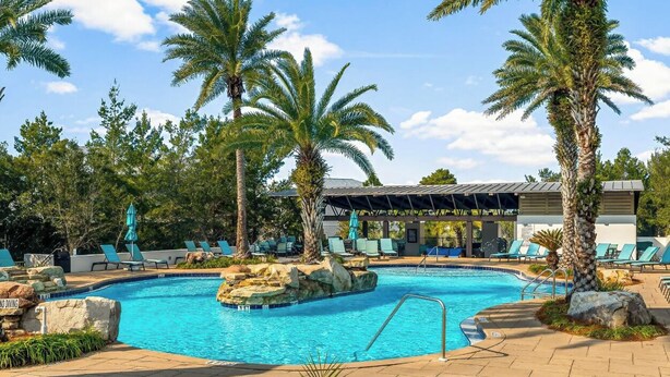 A swimming pool surrounded by palm trees and lounge chairs. - 🦩Book Me Baby! ~ Take It Easy On 30A🦩 (Santa Rosa Beach)