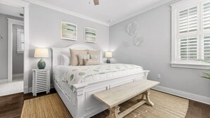 A bedroom with a bed, bedside lamps, a wooden bench, a ceiling fan, and decorative wall art. - 🦩Book Me Baby! ~ Take It Easy On 30A🦩 (Santa Rosa Beach)