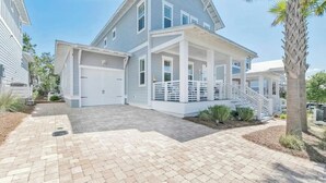 A two-story house with a covered porch and a staircase leading to the garage. - 🦩Book Me Baby! ~ Take It Easy On 30A🦩 (Santa Rosa Beach)