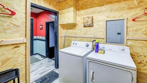 A laundry room with two washing machines, a red wall, and a wooden ceiling. - 1 Mi to Hatfield-McCoy Trails: Apt in Matewan (Matewan)