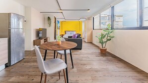 A modern apartment with a kitchen, dining area, and a living space with a view.