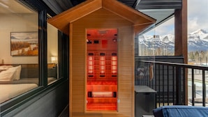 A sauna with a wooden exterior and a view of snow-capped mountains. - 1,250 SF Luxury Home | 4-BR + 3-BA & 8 Beds | Best Amenities in Canmore (Canmore)