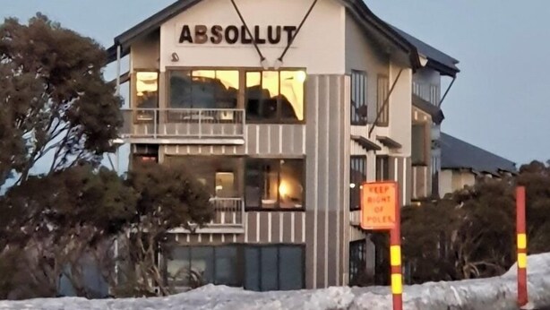 A building with the sign 'ABSOLLUT' on the facade, indicating it is a hotel. - Absollut 9 - Central location (Mount Hotham)