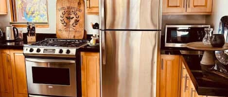 Fridge, coffee/tea maker, cookware/dishes/utensils