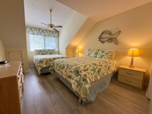 A bedroom with two beds, a ceiling fan, a fish wall decoration, and a nightstand with a lamp. - W Hyde Pk 8E in Kingston 2nd floor, Pool, Beach (Myrtle Beach)