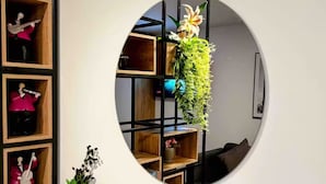 A circular wall decoration with a hanging plant and a small vase with flowers. - The best apartment in the best area of Bogota (Bogotá)