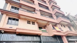 A multi-story building with balconies and a gated entrance. - G1 Studio with a lift,balcony &underground parking (Nairobi)