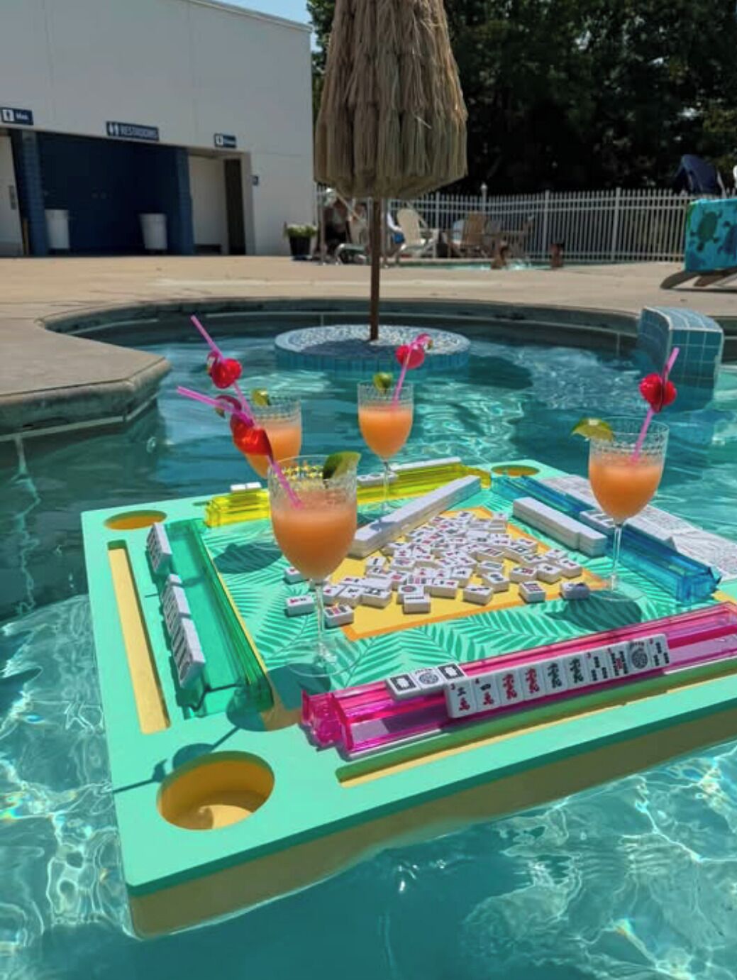 A pool area with a Mahjong table and drinks.