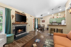 Smart TV, fireplace, books, stereo