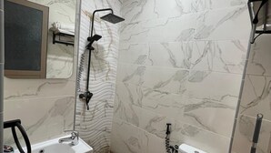 A bathroom with a shower, toilet, and sink.
