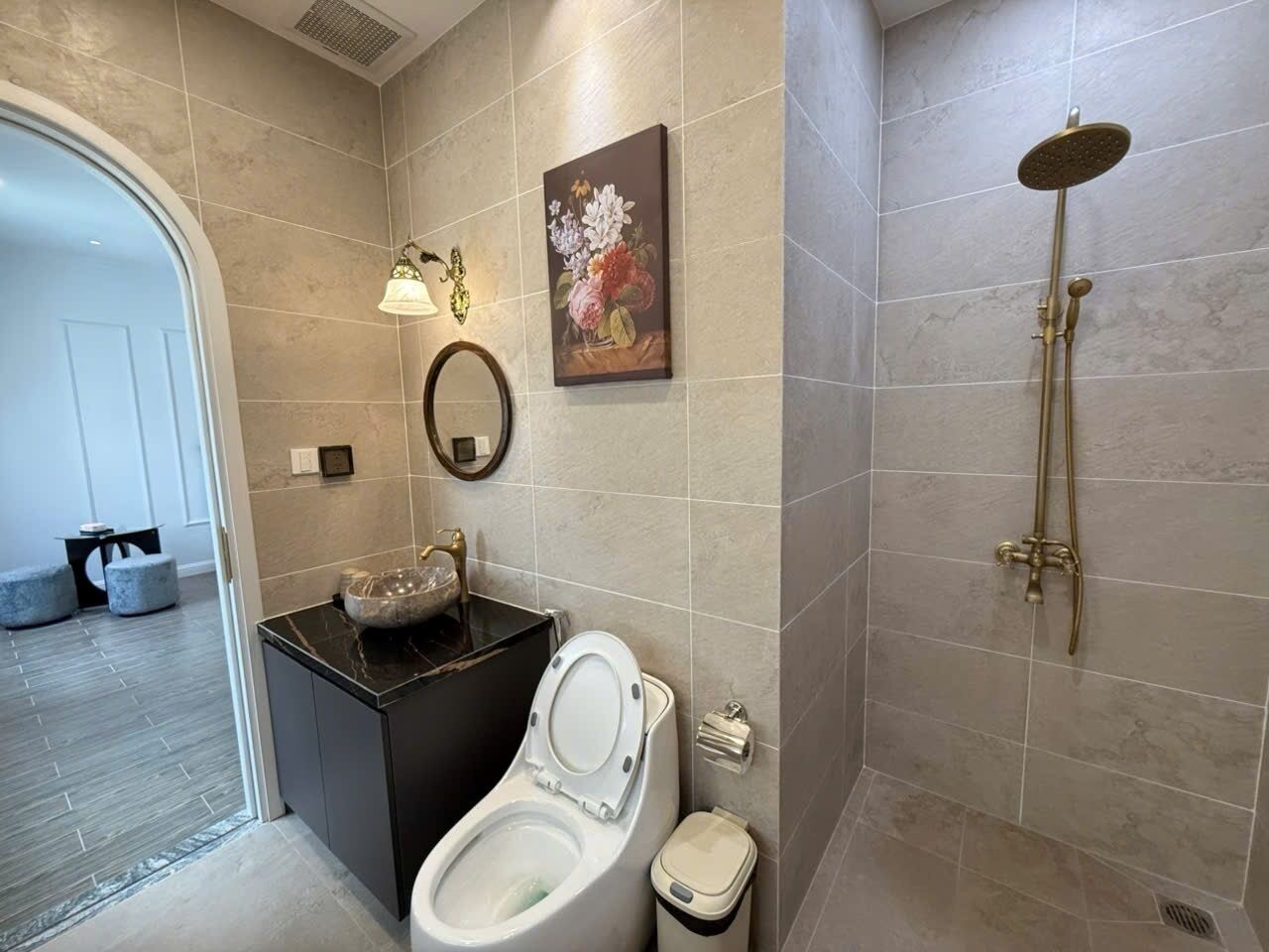 A modern bathroom with a toilet, sink, and shower.