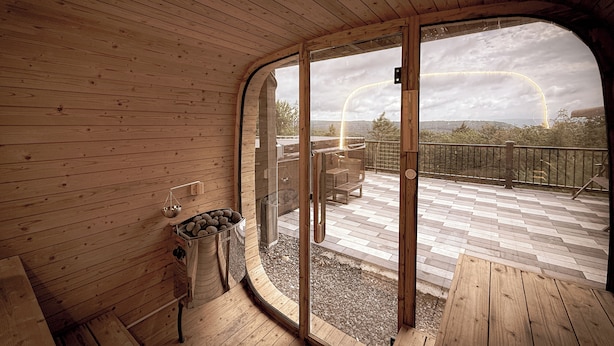 A wooden interior with a glass door leading to an outdoor deck.