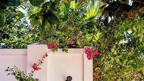 A private beachfront area sign, a shower, and lush greenery. - Oceanfront Villa at Bang Po Beach (Koh Samui)