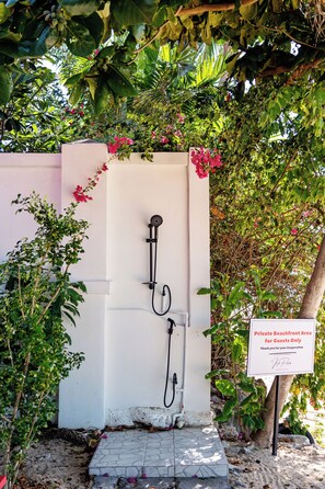 A private beachfront area sign, a shower, and lush greenery. - Oceanfront Villa at Bang Po Beach (Koh Samui)