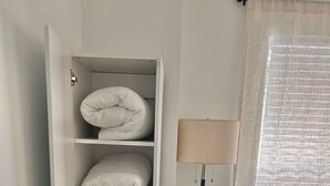 A room with a white wardrobe, a floor lamp, and a window with sheer curtains. - Getaway by Lakes and Florida Southern, Fully Equipped House Near Top Attractions (Lakeland)