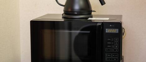 A black microwave with a digital display showing the time as 8:88.