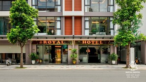 A modern hotel building with a prominent "ROYAL HOTEL" sign. - Royal Hotel - Vinhomes Ocean Park 3 (Nghia Tru)