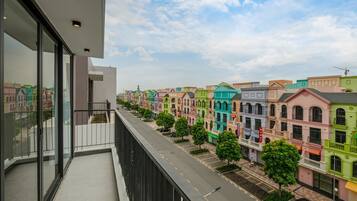 A balcony with a view of colorful townhouses and a clear sky.