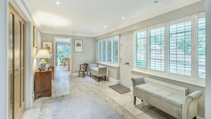 A spacious hallway with a bench, a radiator, and a door leading to a dining area. - 2 bedroom accommodation in Penn (Penn)