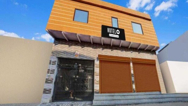 A modern hotel with a sign reading "HOTEL" and a gated entrance. - Shri Yamuna Dham (Mathura)