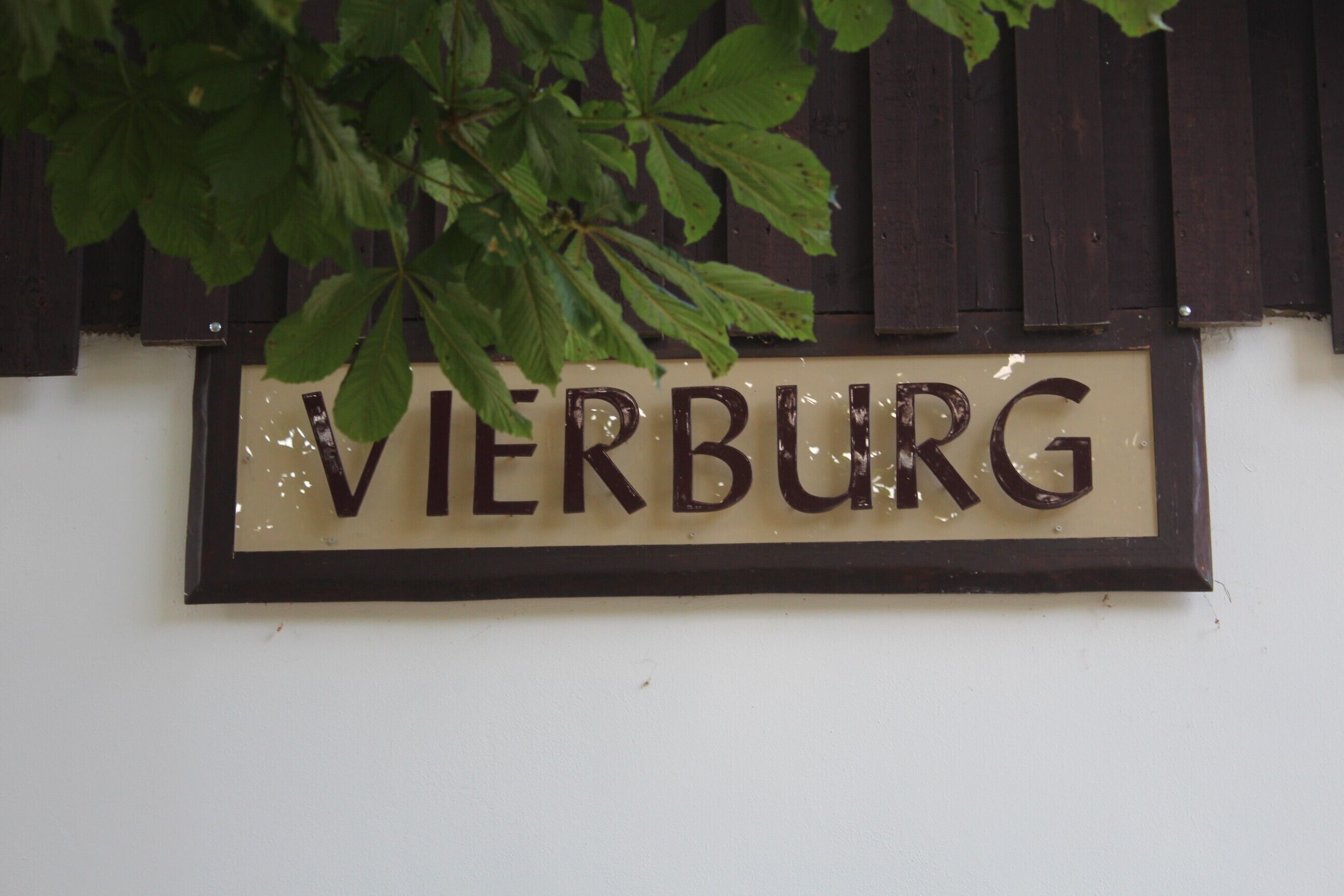 A sign with the word 'VIERBURG' on a wall.