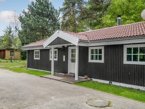 A two-story building with a red-tiled roof, a porch, and a small front yard. - 4 Star Holiday Home in Vig (Vig)