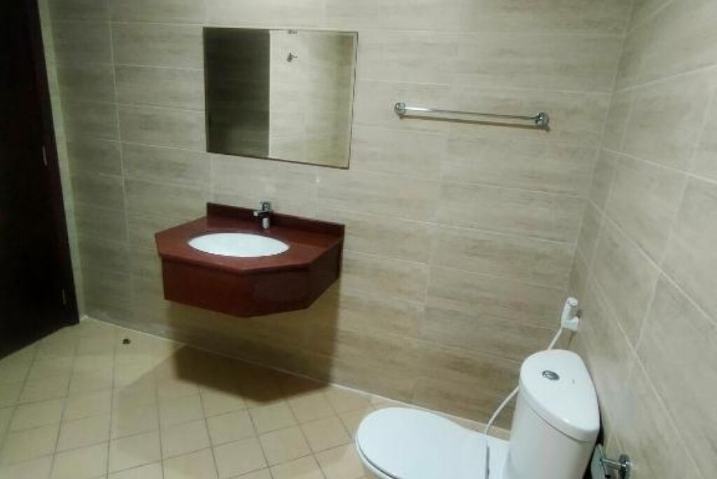 Une salle de bain avec un lavabo, un miroir et des toilettes.