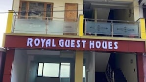 A multi-story building with balconies and a sign reading "ROYAL GUEST HOUSES". - Royal Guest House (Almora)
