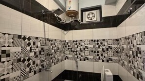 A bathroom with a toilet, a sink, and a shower. - Royal Guest House (Almora)