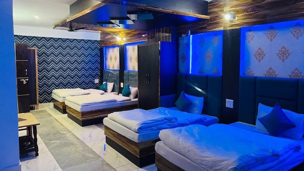 A modern hotel room with two beds, a desk, and a wardrobe. - Royal Guest House (Almora)